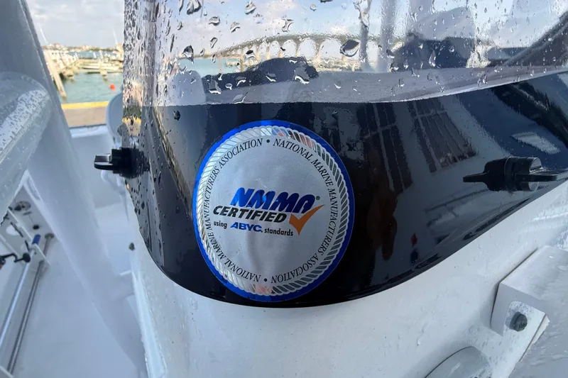 Slide: The Image of 2022 Sportsman Open 232 Center Console with NMMA certification sticker on wet surface. - 39