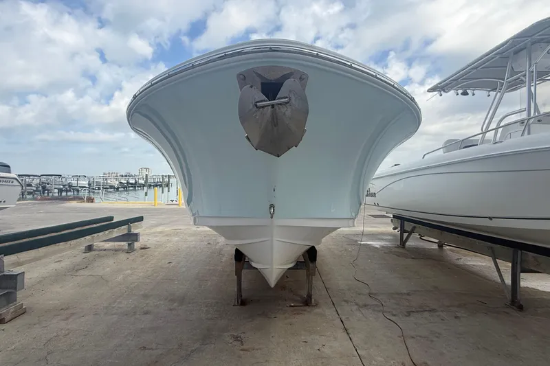 Slide: The Image of 2022 Sportsman Open 232 Center Console boat on a dock, viewed from the front. - 4