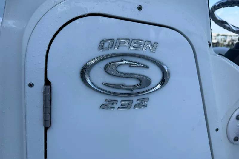 Slide: The Image of 2022 Sportsman Open 232 Center Console boat emblem with water droplets. - 40