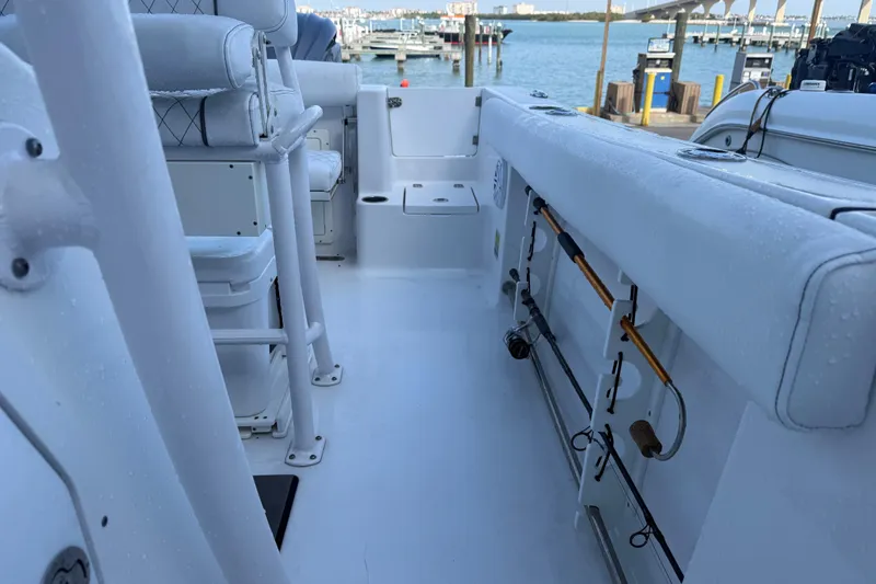 Slide: The Image of 2022 Sportsman Open 232 Center Console boat interior with fishing rod holders. - 41