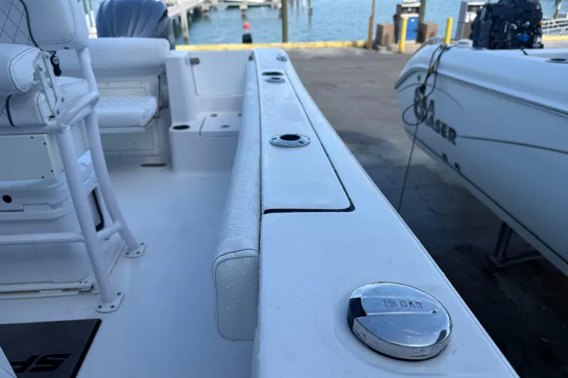 Slide: The Image of 2022 Sportsman Open 232 Center Console boat interior with gas cap and seating. - 42
