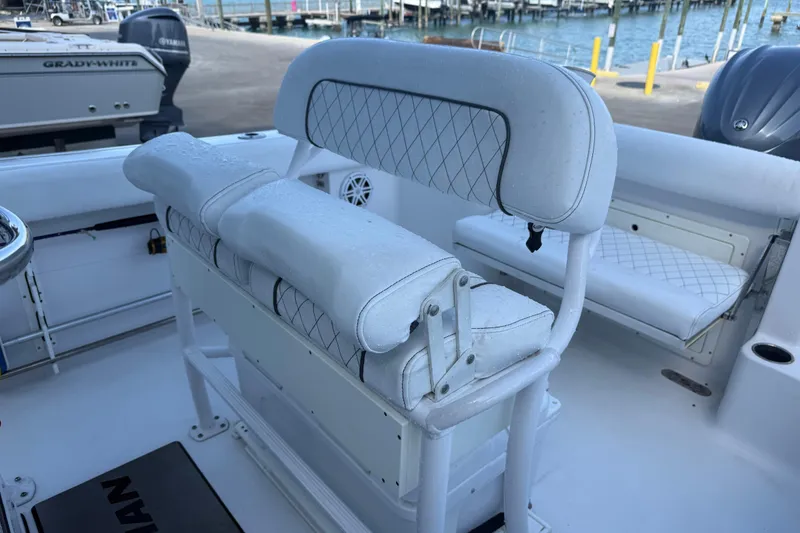 Slide: The Image of 2022 Sportsman Open 232 Center Console boat interior with cushioned seating and storage. - 45