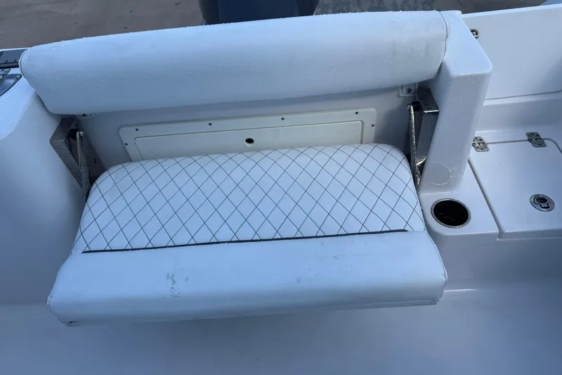 Slide: The Image of 2022 Sportsman Open 232 Center Console boat seat with diamond-patterned upholstery. - 47