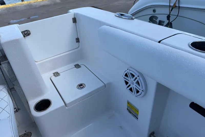 Slide: The Image of 2022 Sportsman Open 232 Center Console boat interior with storage and speaker. - 48