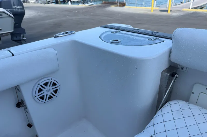 Slide: The Image of 2022 Sportsman Open 232 Center Console boat interior with speaker and seating details. - 49