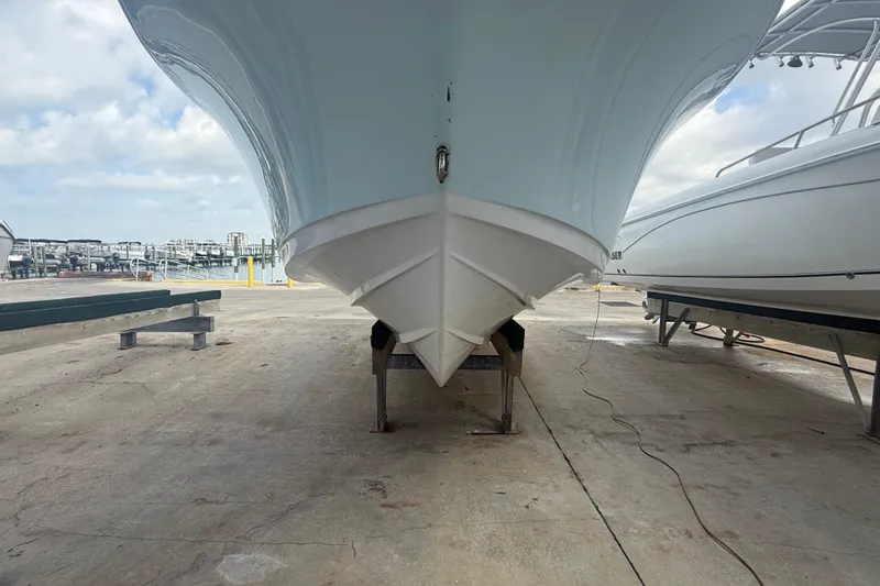Slide: The Image of 2022 Sportsman Open 232 Center Console boat on dry dock, marina background. - 5