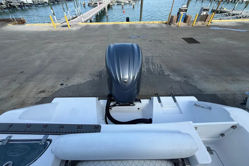 Slide: The Image of 2022 Sportsman Open 232 Center Console boat at dock with outboard motor. - 54