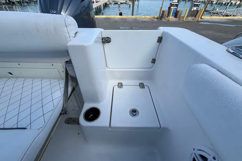 Slide: The Image of 2022 Sportsman Open 232 Center Console boat interior with wet seating and storage. - 56