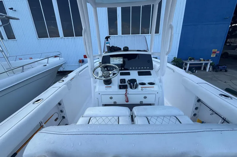 Slide: The Image of 2022 Sportsman Open 232 Center Console boat interior with steering wheel and control panel. - 57