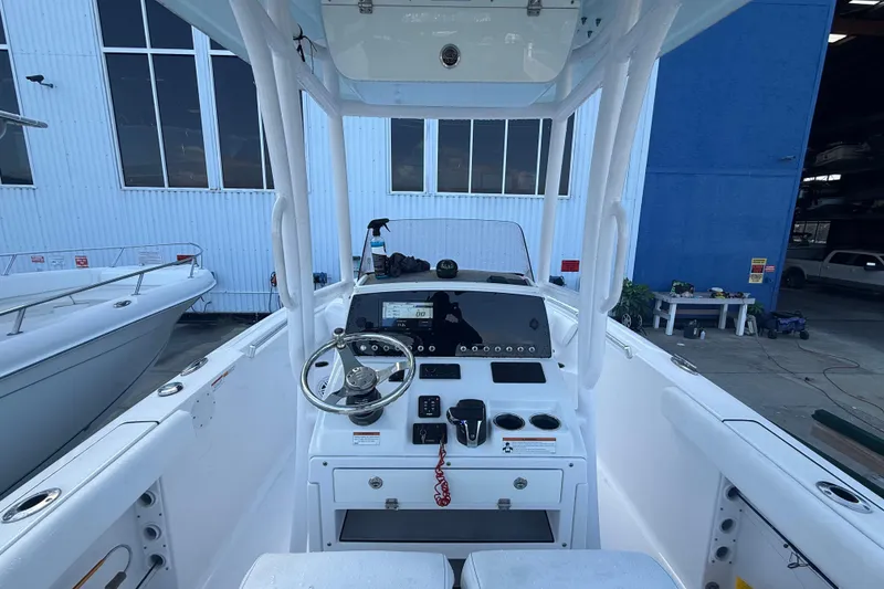 Slide: The Image of 2022 Sportsman Open 232 Center Console boat interior with steering wheel and control panel. - 60