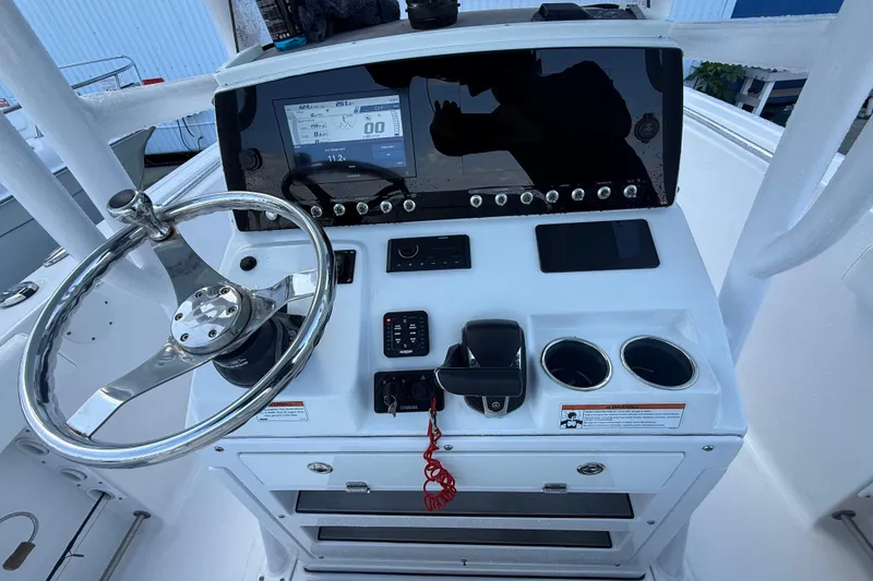 Slide: The Image of 2022 Sportsman Open 232 Center Console dashboard with steering wheel and controls. - 61