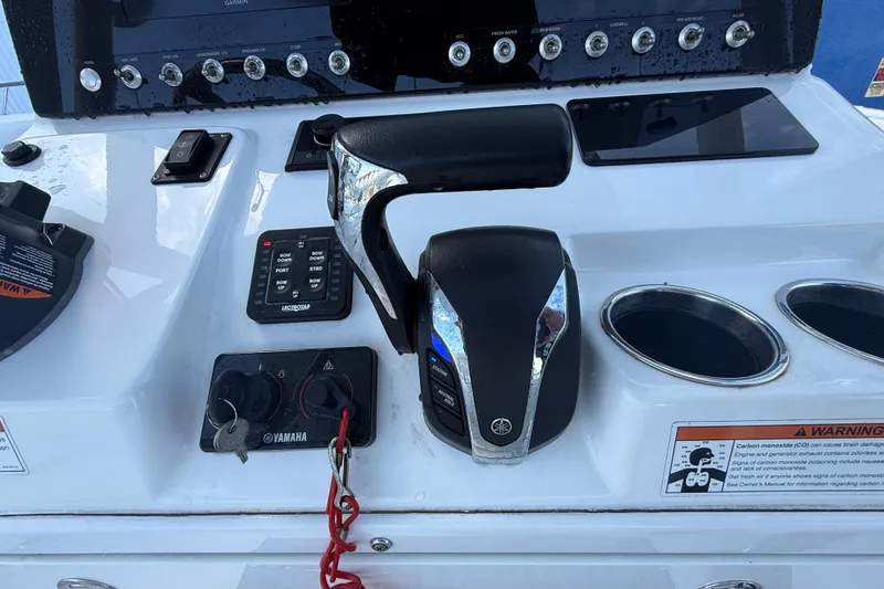 Slide: The Image of Control panel of 2022 Sportsman Open 232 Center Console boat with Yamaha throttle. - 62