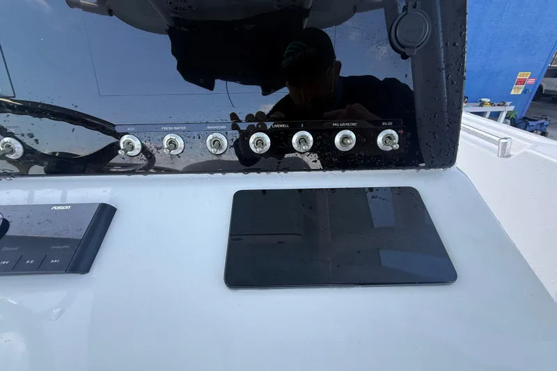 Slide: The Image of 2022 Sportsman Open 232 Center Console dashboard with control switches and touchscreen. - 64