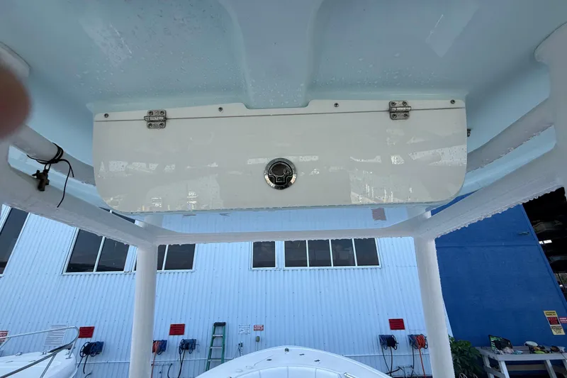 Slide: The Image of 2022 Sportsman Open 232 Center Console boat, viewed from below, showcasing storage compartment. - 66