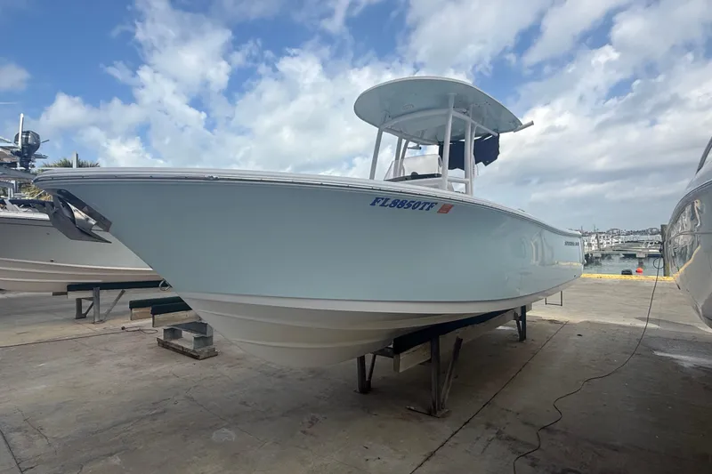 Slide: The Image of 2022 Sportsman Open 232 Center Console boat on dock under cloudy sky. - 8