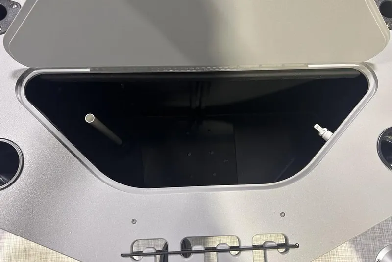 Slide: The Image of Open storage compartment on 2026 Dockside 22DF boat, featuring cup holders and utility fittings. - 4