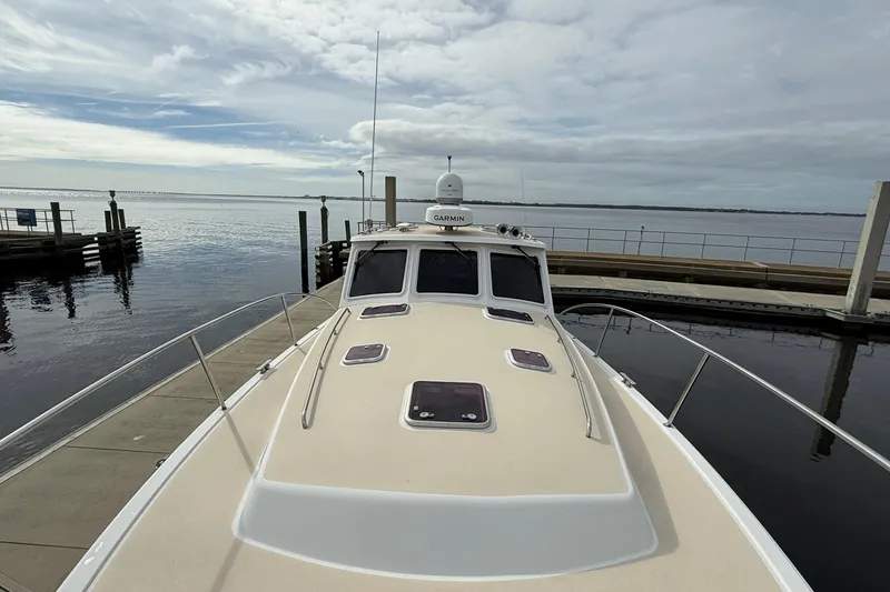 Slide: The Image of 2012 MJM 40z yacht docked at a marina under cloudy skies. - 11