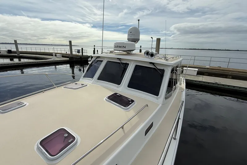 Slide: The Image of 2012 MJM 40z yacht docked at marina under cloudy sky. - 13