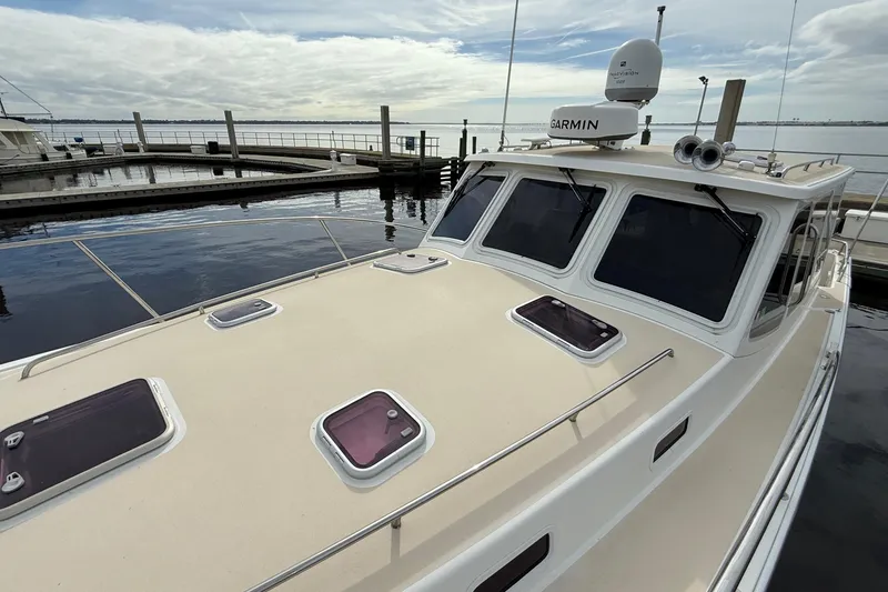Slide: The Image of 2012 MJM 40z yacht docked, featuring Garmin navigation equipment and multiple deck hatches. - 14