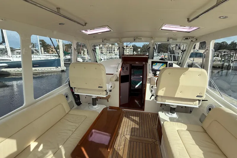 Slide: The Image of Interior of a 2012 MJM 40z yacht with beige seating and navigation equipment. - 17