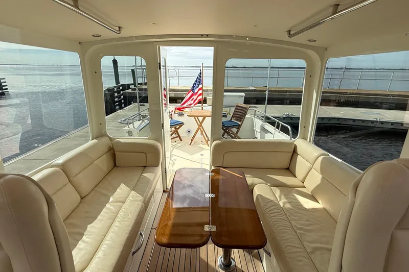 Slide: The Image of Luxurious interior of a 2012 MJM 40z yacht with leather seating and wooden table. - 22
