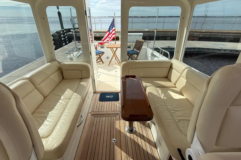 Slide: The Image of Luxurious interior of 2012 MJM 40z yacht with beige seating and wooden table. - 23
