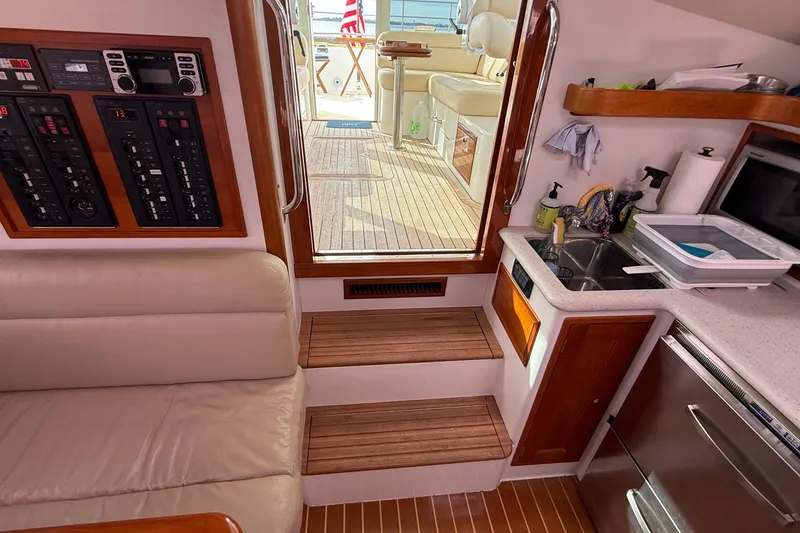 Slide: The Image of Interior of 2012 MJM 40z yacht with seating, control panel, and kitchenette. - 30