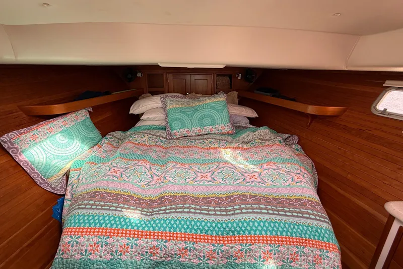 Slide: The Image of Cozy cabin interior of 2012 MJM 40z with colorful bedding and wooden accents. - 36