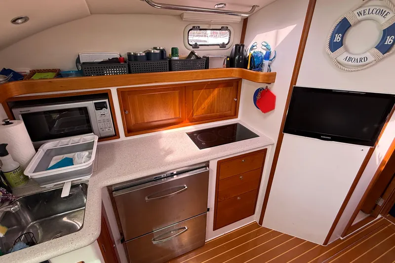Slide: The Image of Modern galley kitchen in 2012 MJM 40z yacht with appliances and wooden cabinetry. - 37