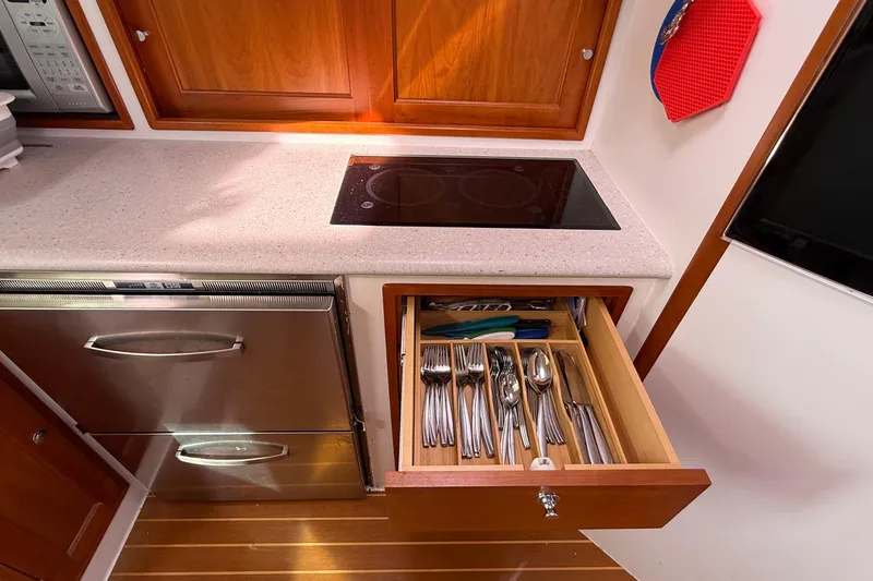 Slide: The Image of Modern kitchen in 2012 MJM 40z yacht with induction cooktop and organized cutlery drawer. - 40