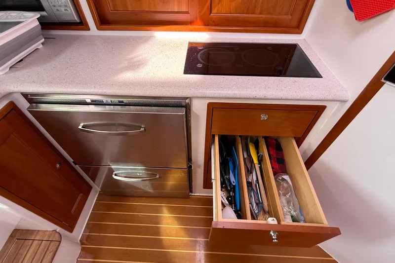 Slide: The Image of Kitchen area of a 2012 MJM 40z yacht with stove, drawer, and stainless steel appliances. - 41