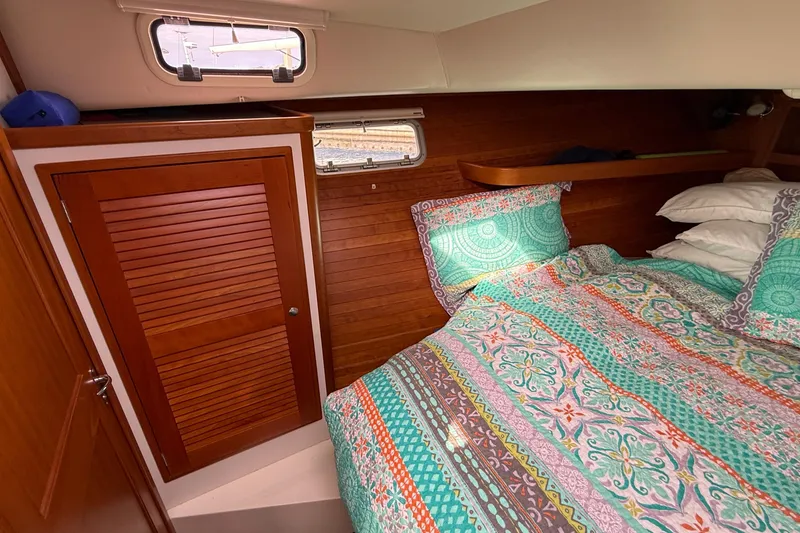 Slide: The Image of Cozy cabin interior of 2012 MJM 40z with colorful bedding and wooden accents. - 51
