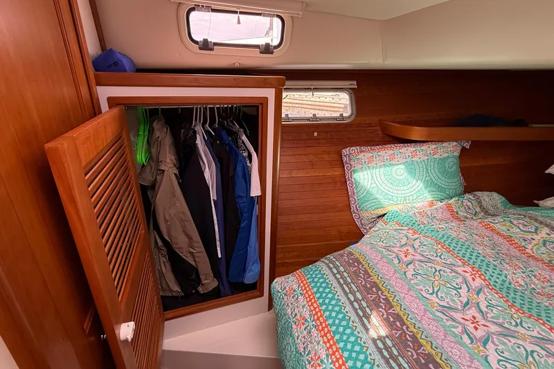 Slide: The Image of Cozy cabin interior of 2012 MJM 40z with colorful bedding and open closet. - 52