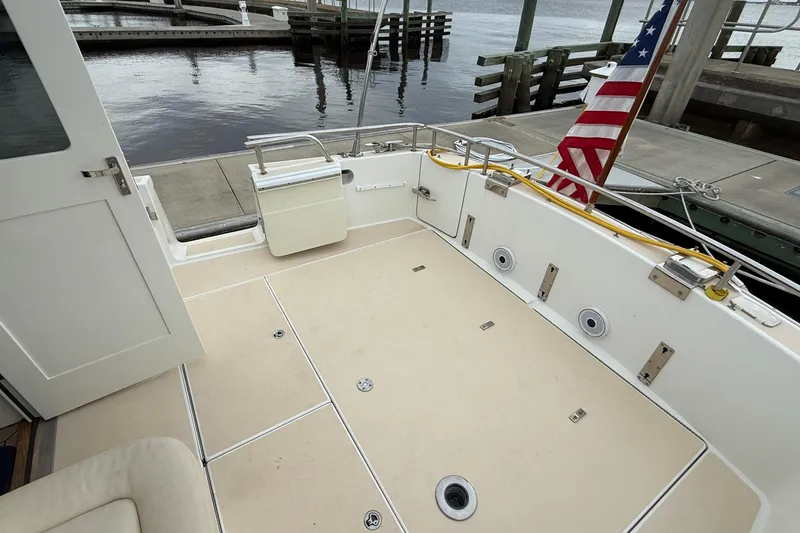 Slide: The Image of 2012 MJM 40z boat deck with American flag at marina. - 58