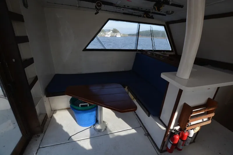 Slide: The Image of Interior of 1983 Key West #1 Sport Fish boat with seating and window view. - 11