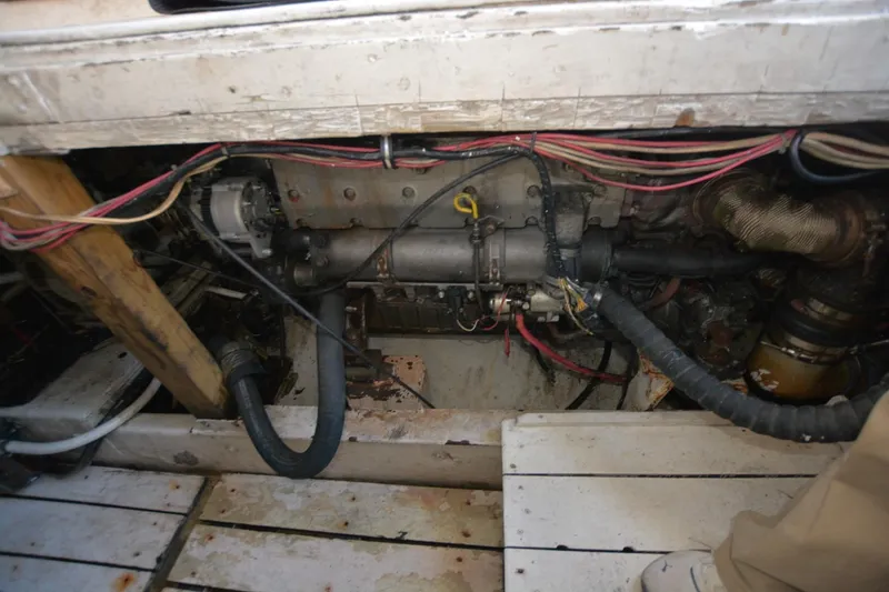 Slide: The Image of Engine compartment of 1983 Key West #1 Sport Fish boat, showing wiring and mechanical components. - 20