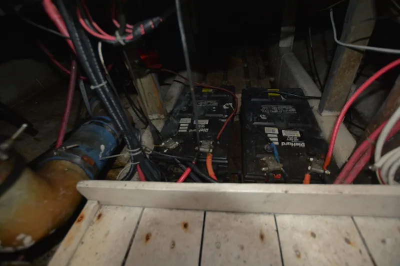 Slide: The Image of Battery compartment of 1983 Key West #1 Sport Fish boat with wiring and components. - 23