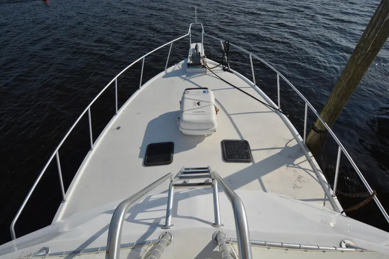 Slide: The Image of 1983 Key West #1 Sport Fish boat deck with railing, docked on calm water. - 3