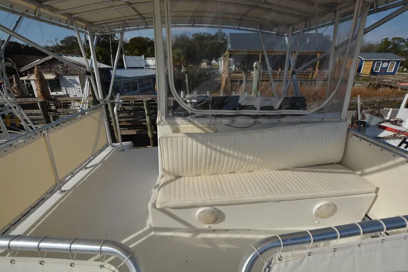 Slide: The Image of 1983 Key West #1 Sport Fish boat with cushioned seating and clear enclosure. - 4