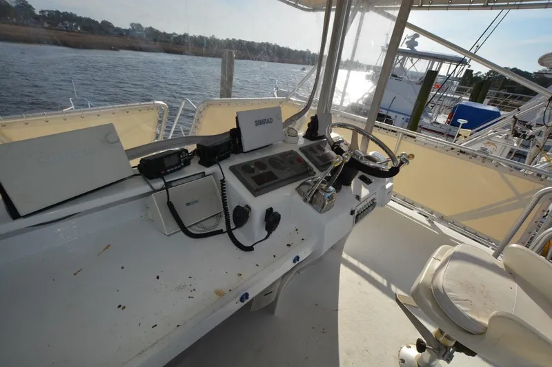 Slide: The Image of 1983 Key West #1 Sport Fish boat cockpit with steering wheel and navigation equipment. - 5