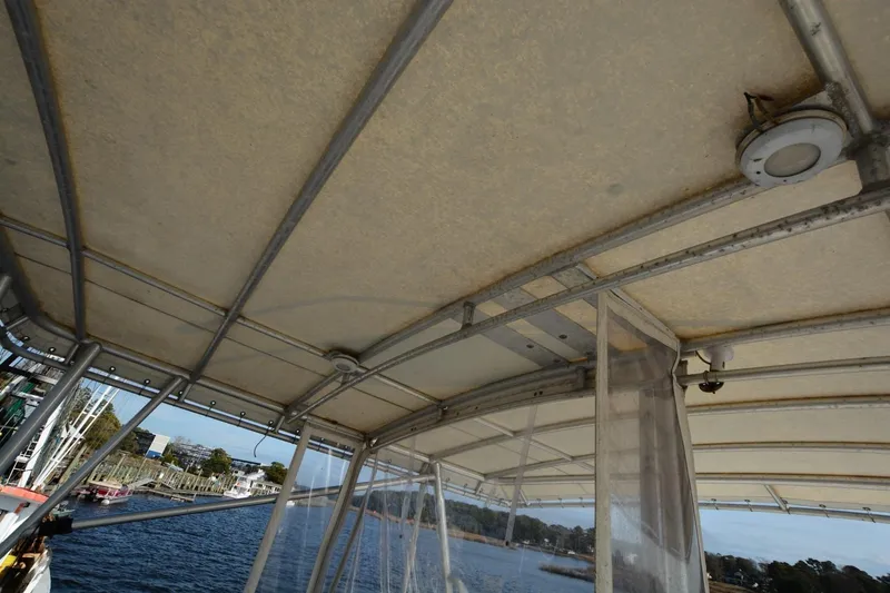 Slide: The Image of 1983 Key West #1 Sport Fish boat canopy with metal frame and water view. - 8