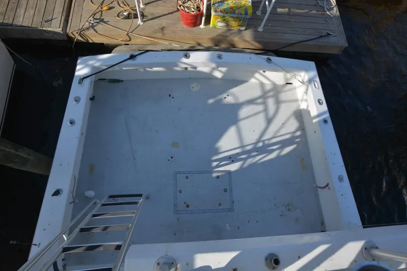 Slide: The Image of 1983 Key West #1 Sport Fish boat deck, docked with fishing gear nearby. - 9