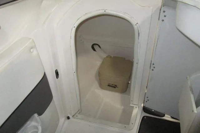 Slide: The Image of 2009 Rinker 276 Captiva Bowrider interior with compact storage compartment. - 13