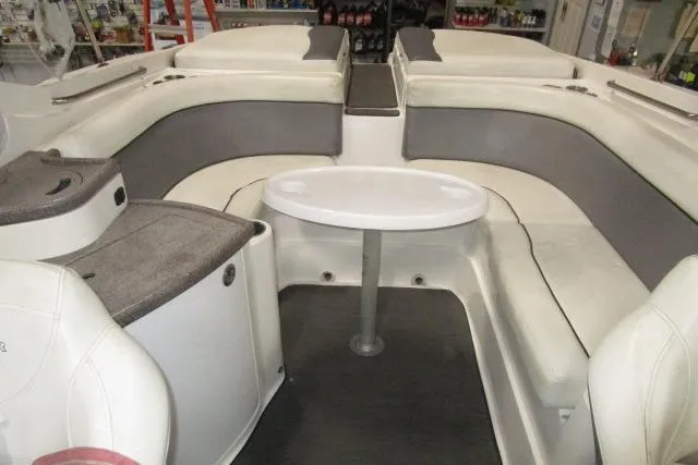 Slide: The Image of 2009 Rinker 276 Captiva Bowrider interior with seating and table, showcasing spacious design. - 14