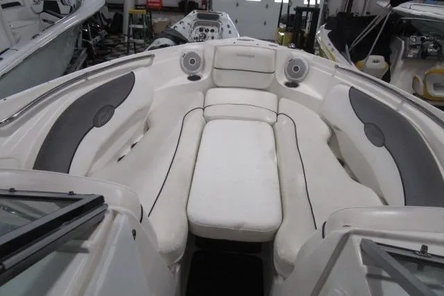 Slide: The Image of 2009 Rinker 276 Captiva Bowrider interior with white seating and speaker system. - 15