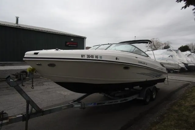 Slide: The Image of 2009 Rinker 276 Captiva Bowrider on trailer, parked outdoors near storage facility. - 3
