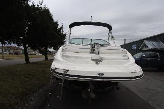 Slide: The Image of 2009 Rinker 276 Captiva Bowrider boat with ladder, parked outdoors on a cloudy day. - 4