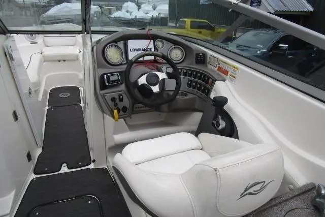 Slide: The Image of 2009 Rinker 276 Captiva Bowrider cockpit with steering wheel and control panel. - 8