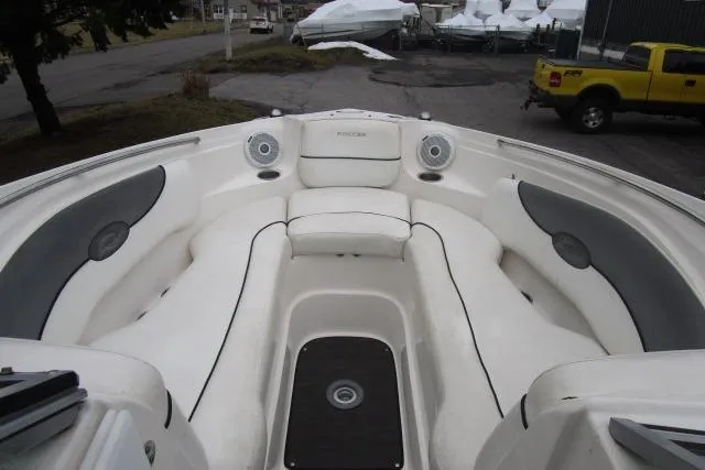 Slide: The Image of 2009 Rinker 276 Captiva Bowrider interior with white seating and speakers. - 9