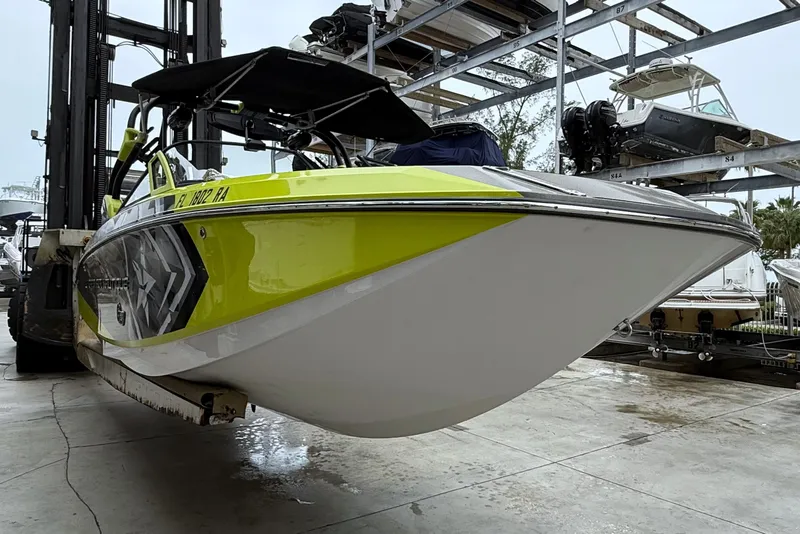 Slide: The Image of 2015 Nautique Super Air Nautique G23 Coastal Edition on forklift in marina. - 10